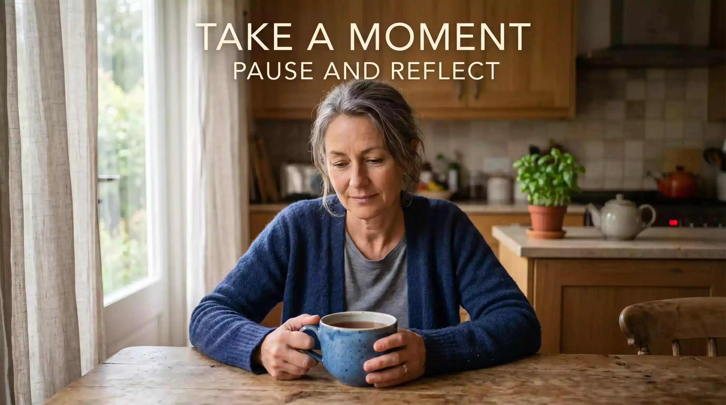 Adult sitting quietly at a kitchen table in a calm UK home setting reflecting in the morning light